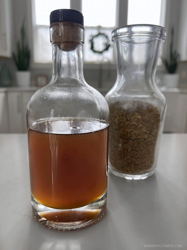 a glass bottle filled with liquid sitting on top of a table