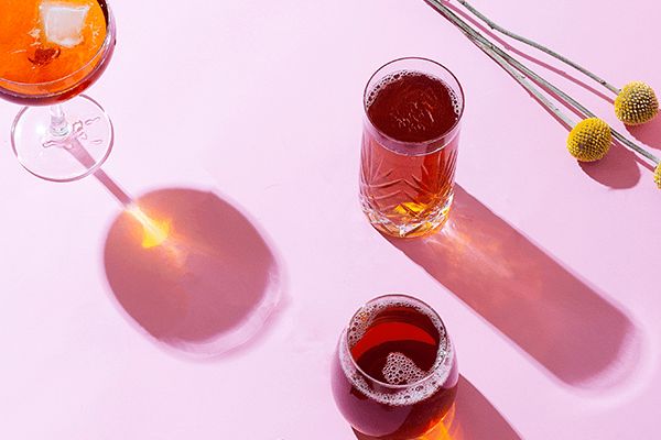 three different types of drinks sitting on top of a white table next to each other