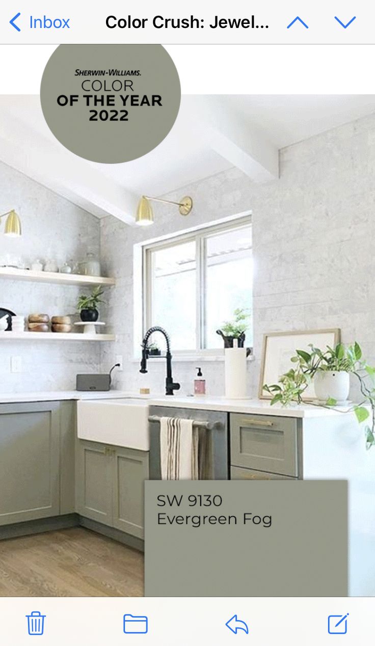 a kitchen with gray cabinets and white walls, the color is off the year 2012