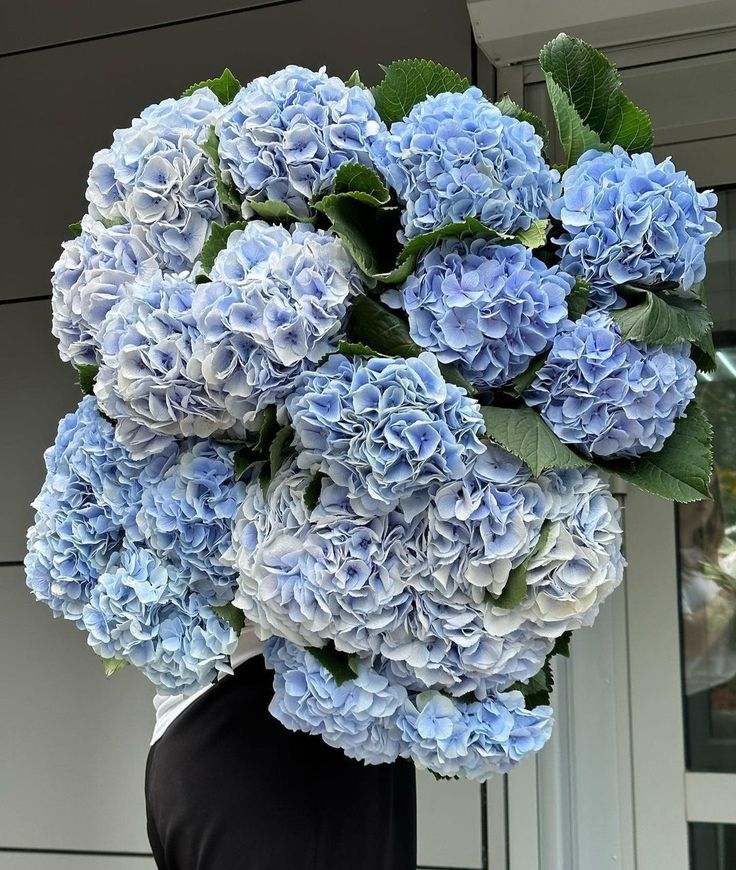 a vase filled with blue flowers sitting on top of a table