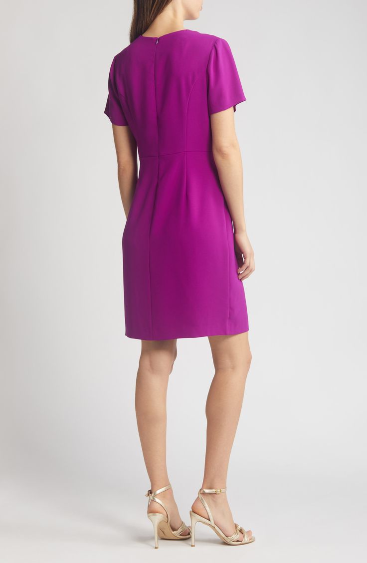 Be ready for your next evening event in this svelte sheath dress fashioned with an oversized bow at the bodice and a face-framing V-neckline. 38" length (size 6) V-neck Short sleeves Lined 100% polyester Dry clean Imported Elegant Purple Mini Dress, Sleek Workwear Dresses With Fitted Bodice, Elegant Mini Dress With Flattering Cut For Formal Occasions, Elegant Flattering Mini Dress For Formal Events, Elegant Mini Dress With Flattering Cut For Formal Events, Fitted Bodice V-neck Dress For Work, V-neck Dress With Fitted Bodice For Work, Evening Dresses With Flattering Cut, Formal Dresses With Flattering Silhouette And Straight Neckline