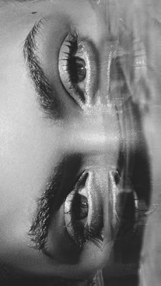 a black and white photo of a woman's eyes