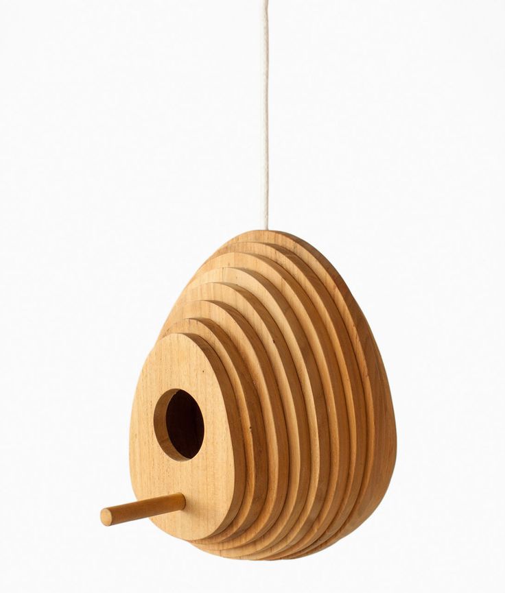 a wooden bird house hanging from a string