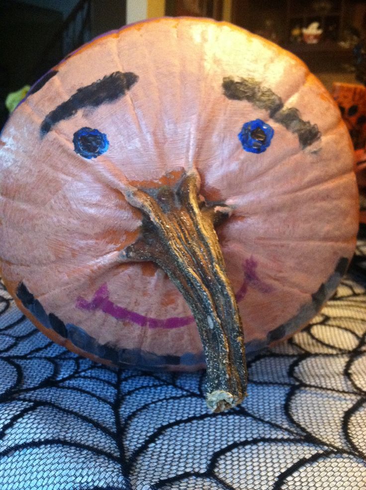 a close up of a paper plate shaped like a face with blue eyes and eyebrows