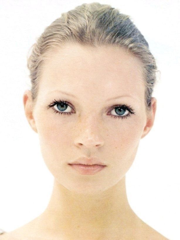 a woman's face is shown with blue eyes