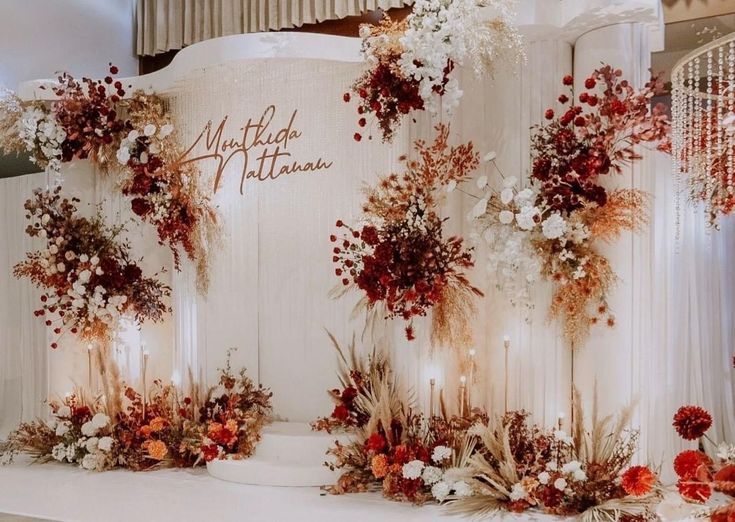 an image of a wedding stage setting with flowers and candles on the side for decoration