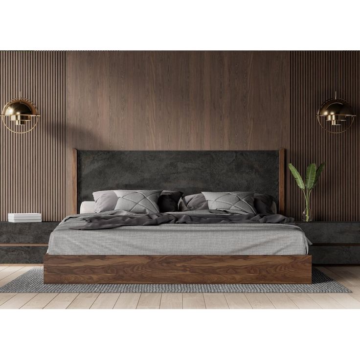 a large bed sitting in the middle of a room next to a wall with wooden paneling