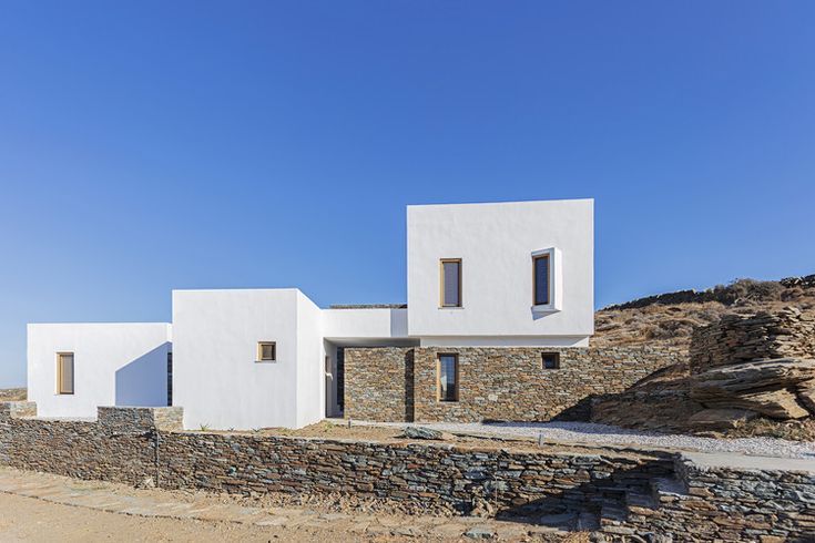 two white houses on the side of a hill