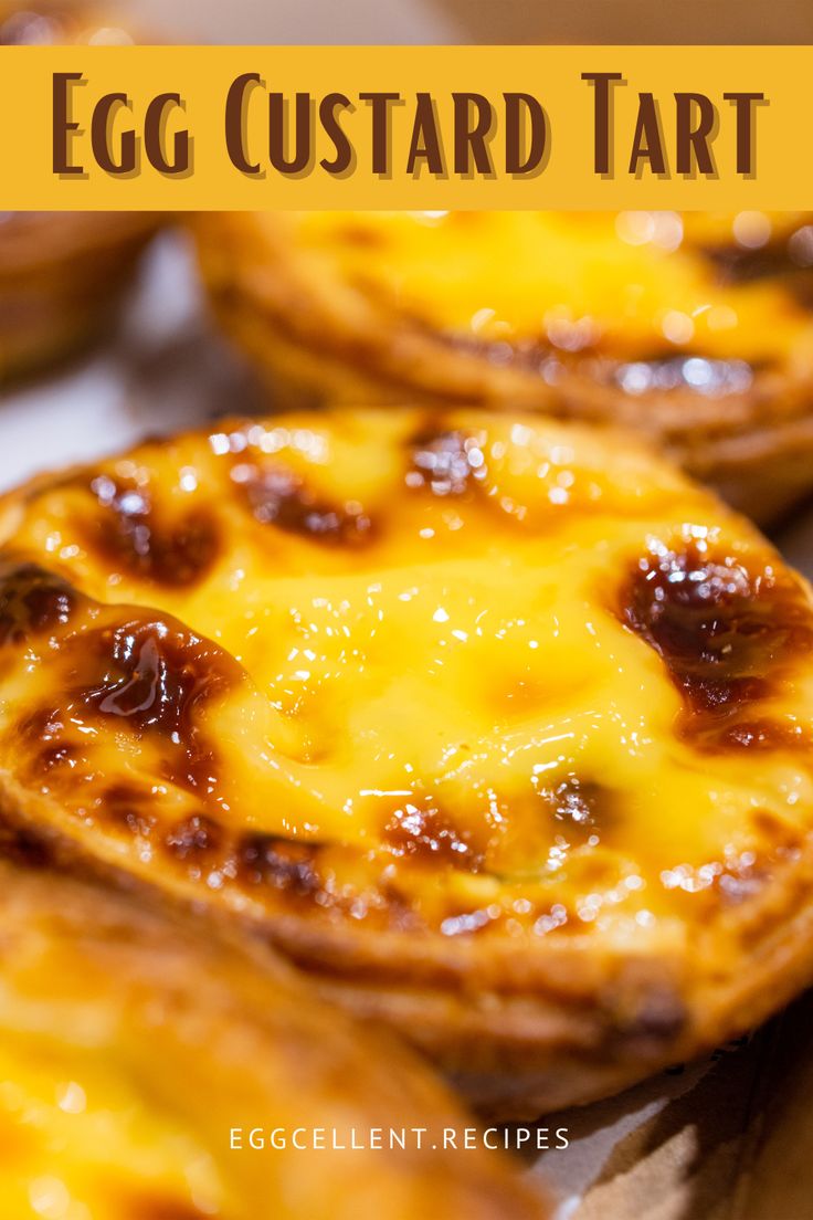 an egg custard tart with cheese on top and the words egg custard tart above it