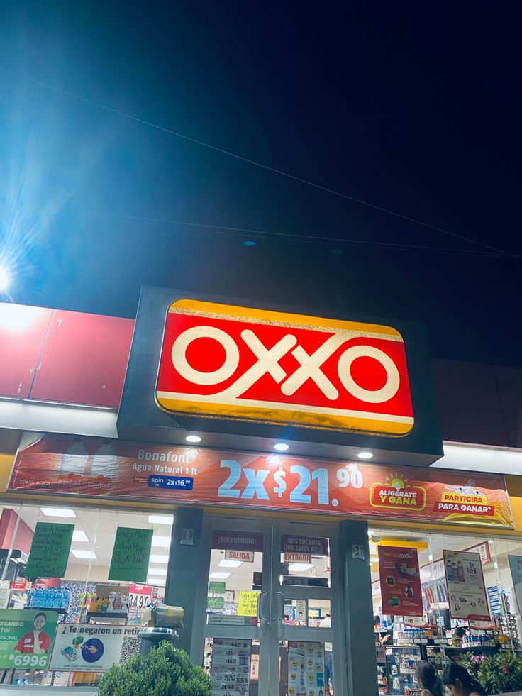 an ox convenience store sign lit up at night