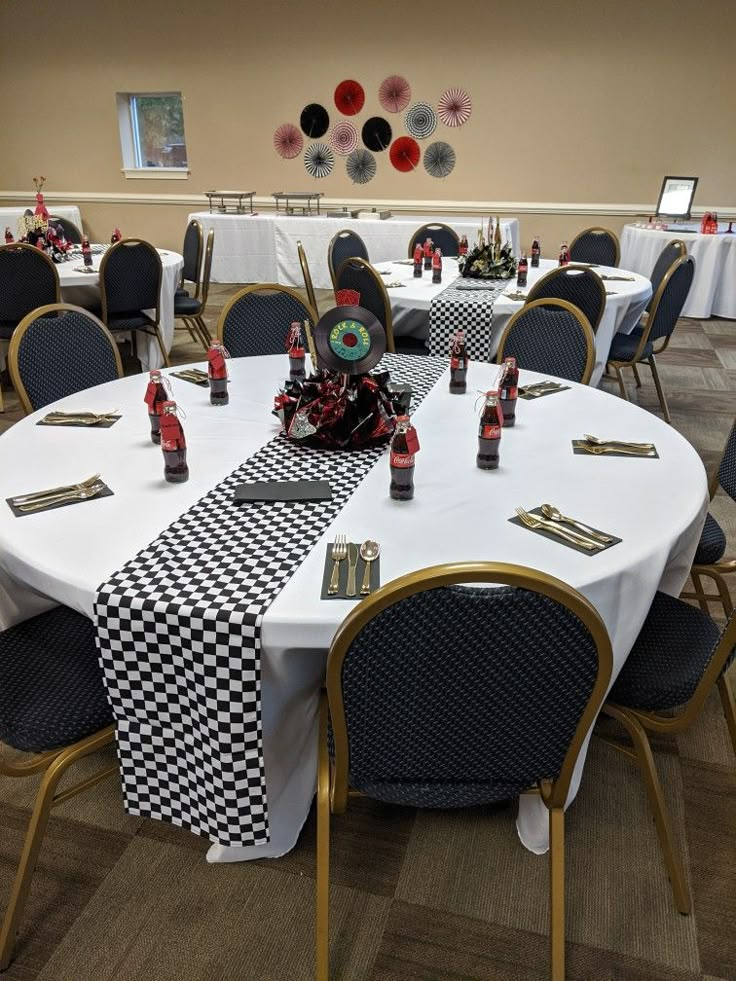 a banquet room set up with black and white table cloths