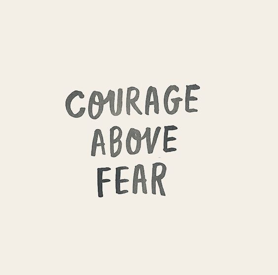 the words'courage above fear'are drawn in black ink on a white background