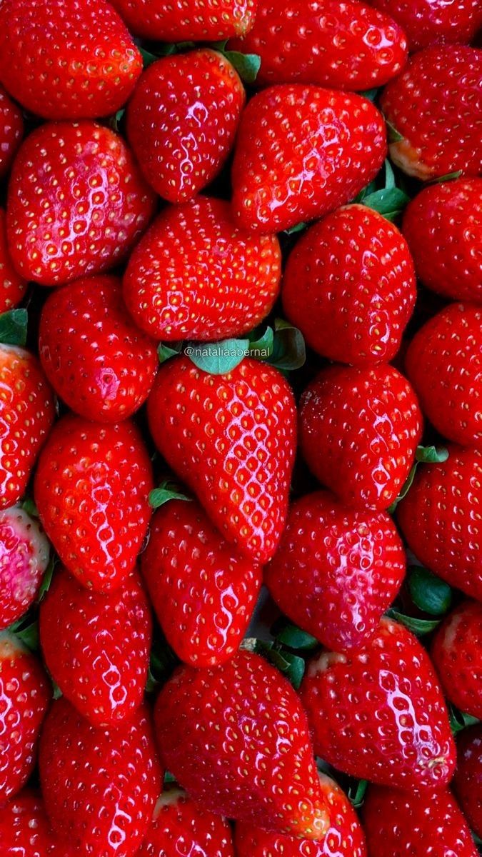 a pile of red strawberries sitting on top of each other