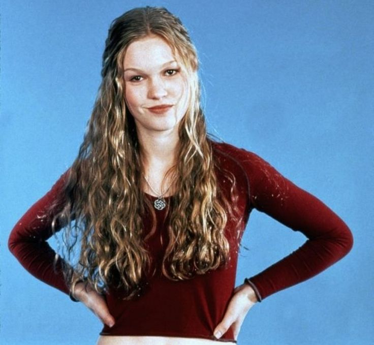 a young woman posing for a photo with her hands on her hips