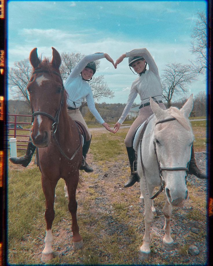 two people riding horses in an open field