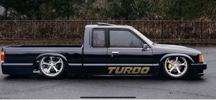 a black truck parked in a parking lot