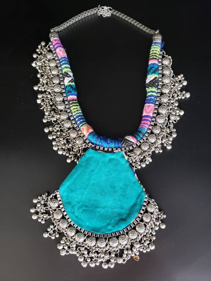 "Dramatic hand crafted silver tone boho statement necklace with fascinating sun pendant. Toss it on a black or pink tank top to renew a tired outfit. Beautiful, multilayered, eye catching piece. Wear this and you WILL be noticed! Visually striking and dramatic! Fabric backing for comfort. Fine quality and craftsmanship. Fabric will vary slightly from piece to piece, but the color palette is the same! Like they say \"Go big or go home\". Live to the fullest! Love the necklace but want it in a gol Hippie Festival Pendant Necklace, Handmade Metal Necklace For Festivals, Bohemian Handmade Pendant Bib Necklace, Handmade Bohemian Pendant Bib Necklace, Unique Boho Collar Jewelry For Festival, Handmade Long Bib Necklace For Festivals, Bohemian Jewelry With Large Pendant For Festivals, Bohemian Large Pendant Jewelry For Festivals, Traditional Summer Necklace