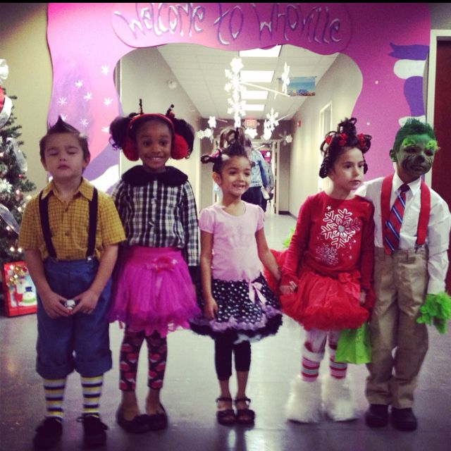 four children in costumes standing next to each other