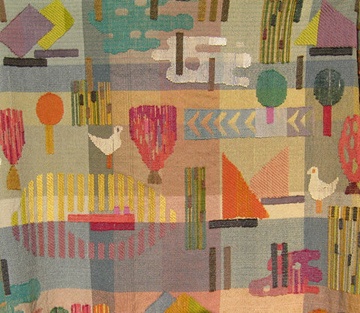 an abstract quilt with birds, boats and other things on the ground in front of it