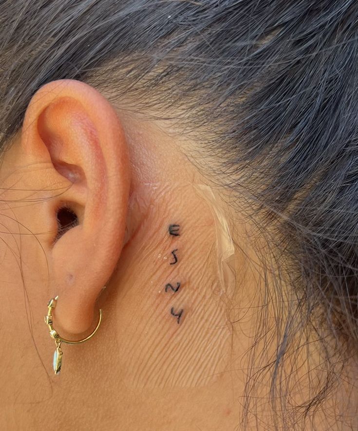 a woman's ear with the word love written on it