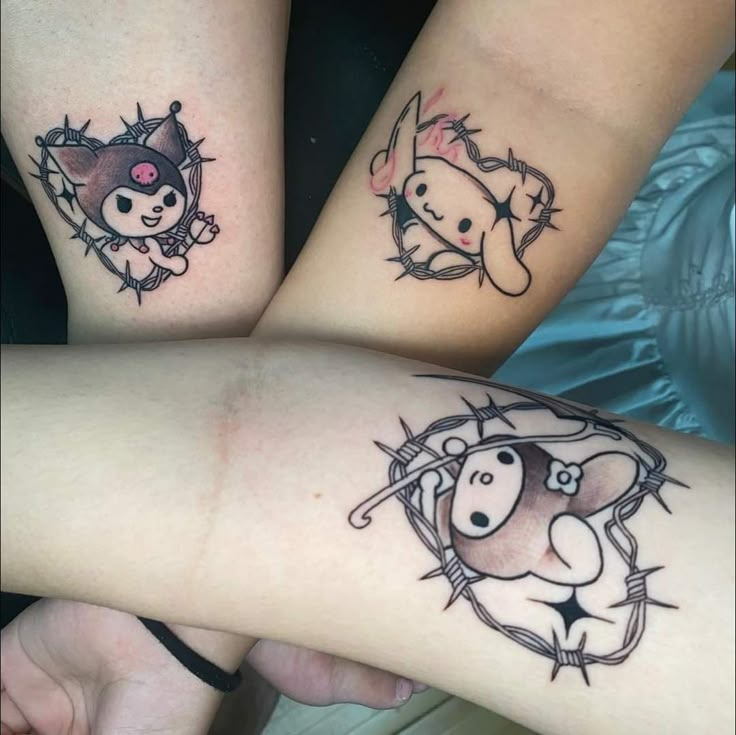 three people with tattoos on their arms