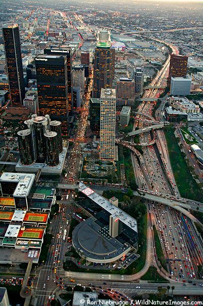 an aerial view of a city with lots of tall buildings and cars on the road