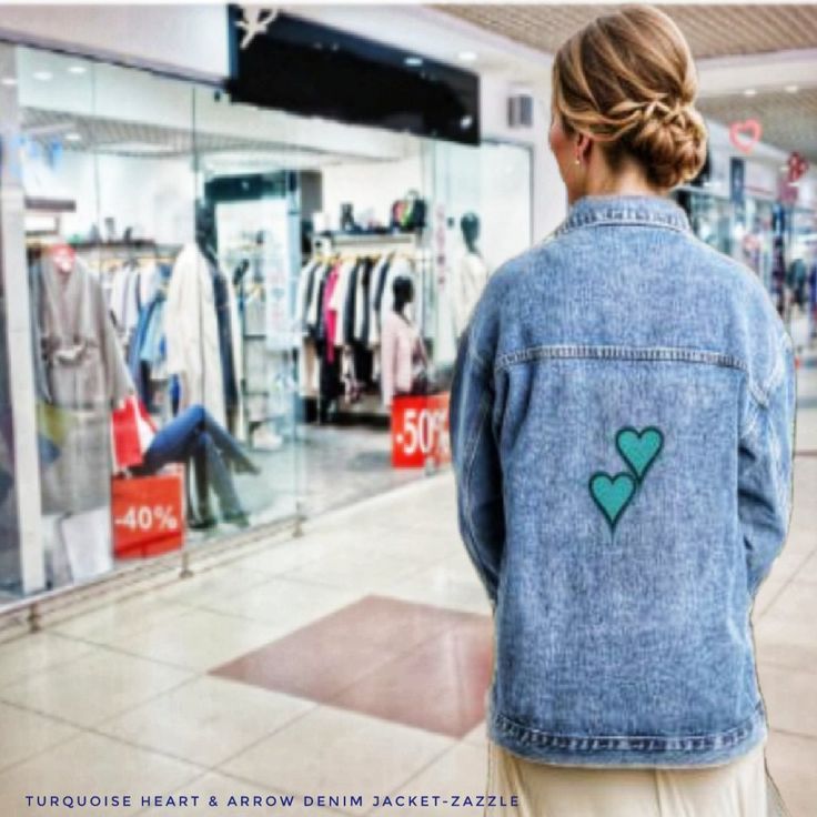 a woman standing in front of a clothing store with her back turned to the camera