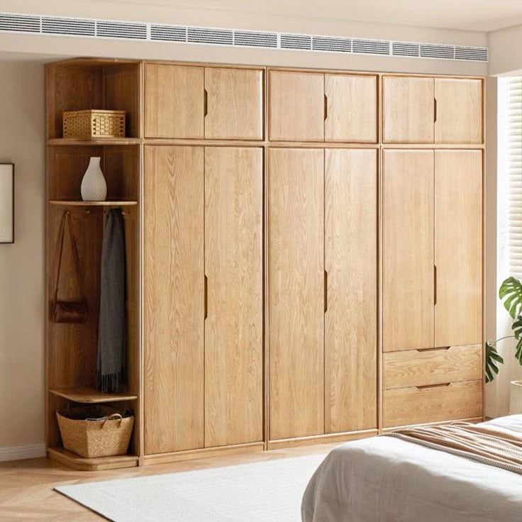 a bedroom with a bed, dresser and closets in the corner next to a window