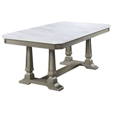 a white marble top dining table with metal legs and two columns on the base,