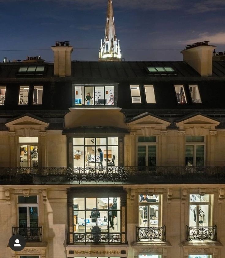 an apartment building with many windows at night