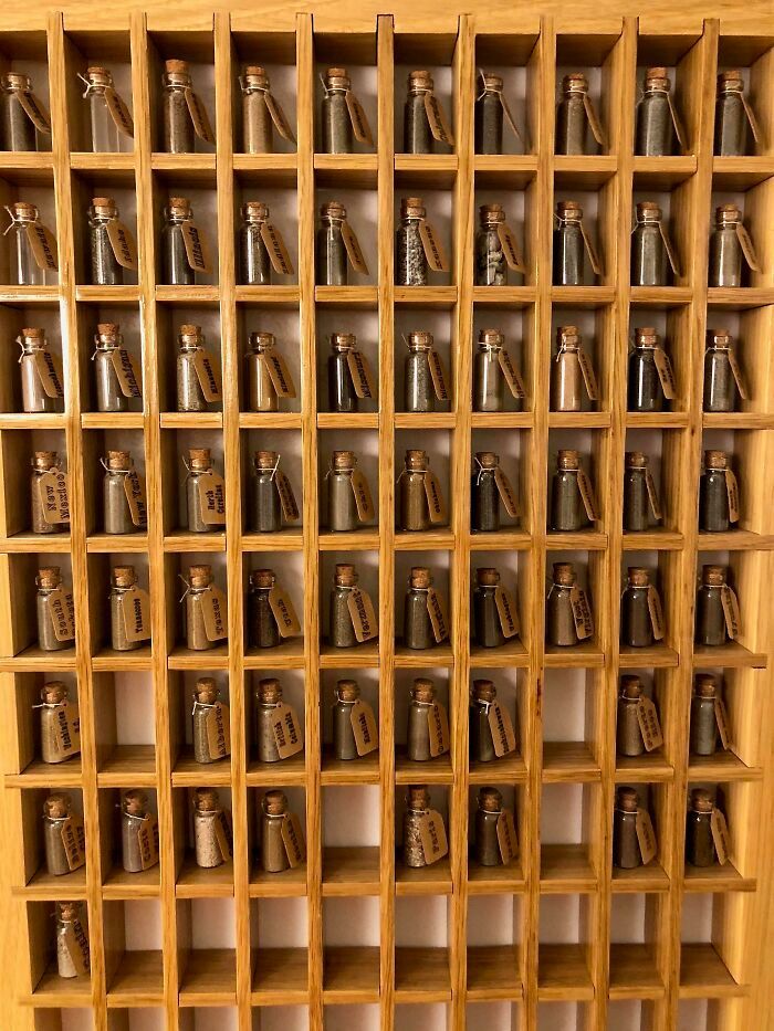 a wooden shelf filled with lots of metal items