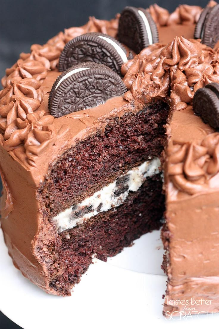 a chocolate cake with oreo cookies on top and one slice cut from the cake