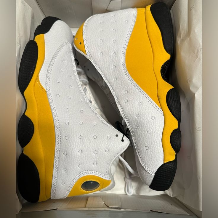 The Air Jordan 13 Retro Del Sol Is A Colorway Of The Iconic Air Jordan 13 Worn By Mj Throughout Most Of The 1998 Postseason. This Sneaker Is Dressed In A White, Del Sol, University Red, And Black Color Scheme. The Hits Of Yellow Are On The Suede Overlays, While Hits Of White Are Visible On The Shoe’s Panels, Toe, And Tongues. The Red Is On The Jumpman Logo Embroidered On The Tongue, While The Black Is Visible On The Shoe’s Rubber Outsole. . Sporty Yellow Jordan Lace-up Shoes, Yellow Jordan Shoes With Cushioned Footbed For Sports, Yellow Synthetic Basketball Shoes With Cushioned Footbed, Yellow Jordan Sports Shoes With Branded Insole, Yellow Jordan Sports Shoes With Round Toe, Sporty Yellow Jordan Shoes With Round Toe, Yellow Sneakers With Perforations And Round Toe, Yellow Sporty Sneakers With Perforations, Yellow Perforated Sneakers For Streetwear