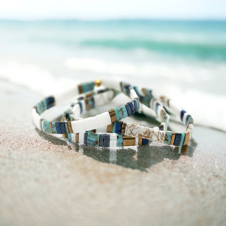 a couple of bracelets sitting on top of a sandy beach Tila Bead Bracelets, Tila Bracelets, Bracelets Stack, Stackable Beaded Bracelets, Bracelet Stacks, Stretchy Beaded Bracelet, Tidal Wave, Bracelet Kits, Paracord Bracelets