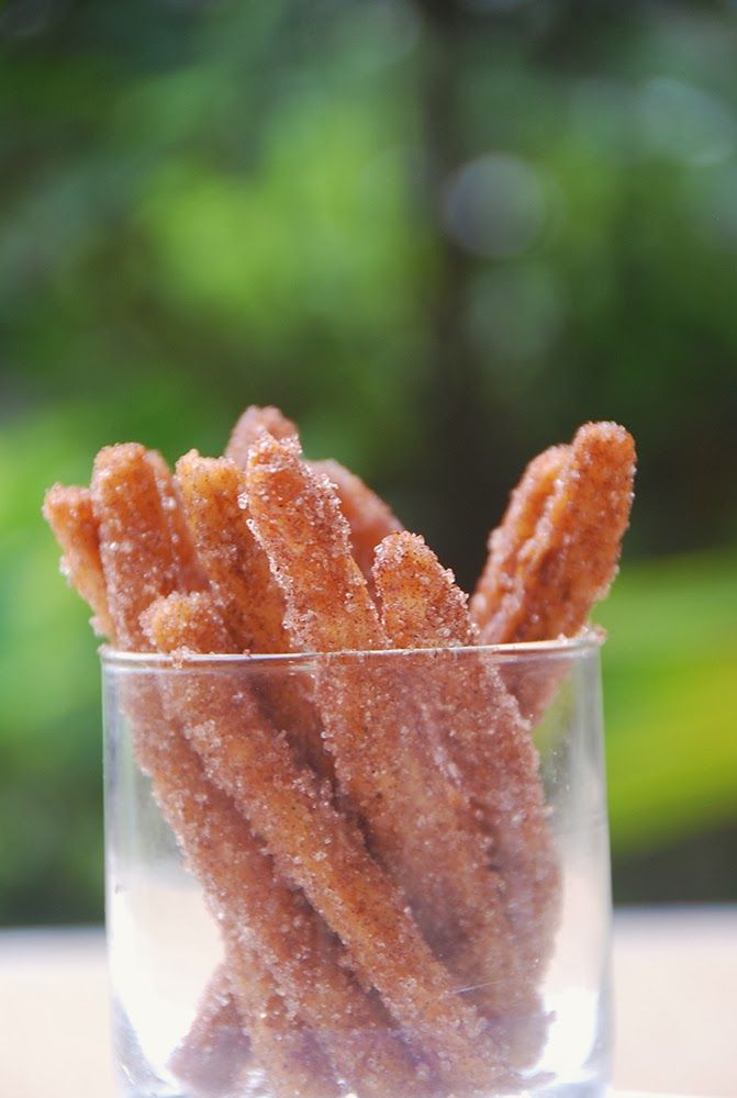 a glass filled with sugary treats sitting on top of a table