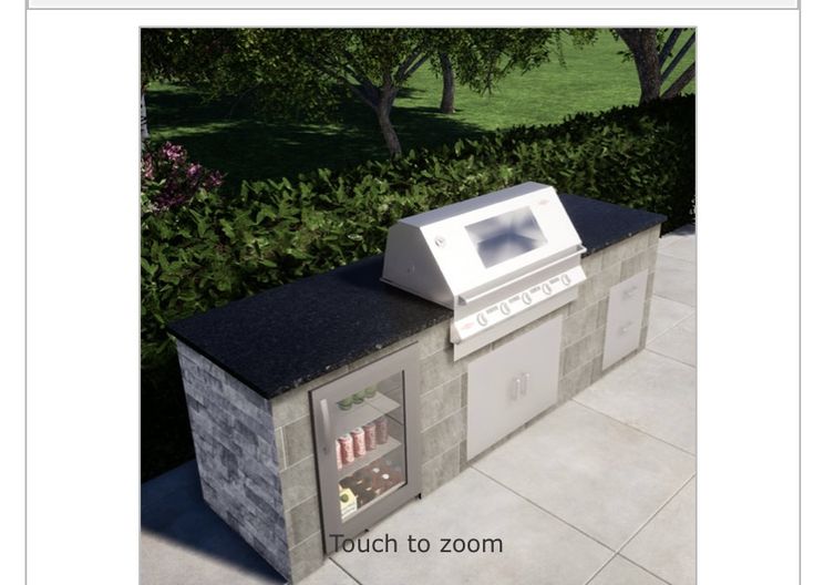 an outdoor kitchen made out of cinder blocks with a microwave oven on the outside wall