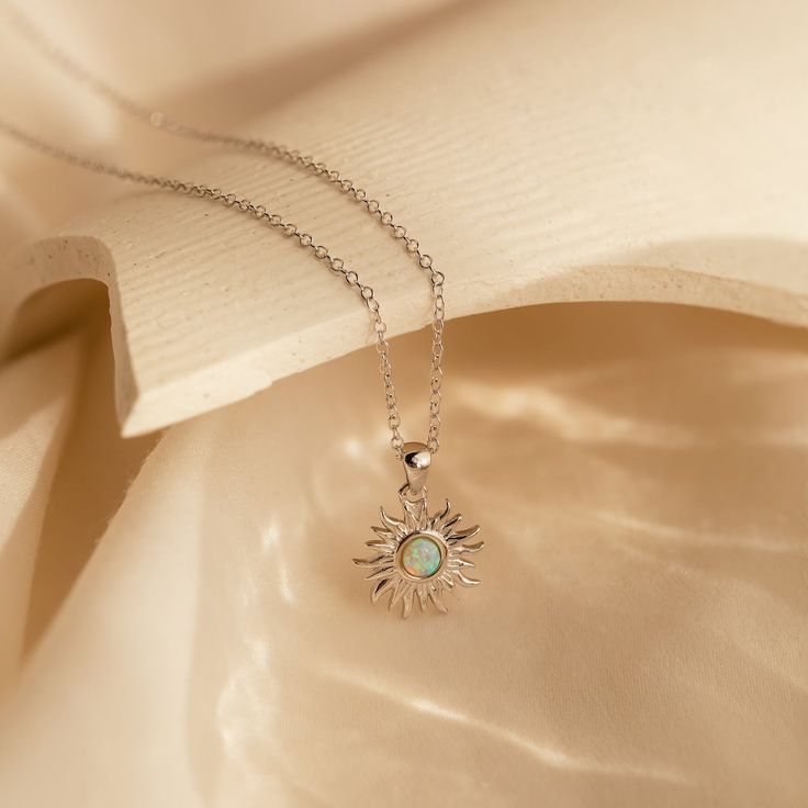 🕑Last Chance: Hurry and save 40% 🕑 Bohemian and dreamy is our Opal Sun Necklace. With a prismatic Opal gemstone in the middle of a detailed sun pendant, this dainty necklace is a perfect jewelry gift for someone who brightens your day. Material: High Quality Solid 925 Sterling Silver Finish: 18K Gold Featuring ~12mm Sun Pendant and an ~3.5mm Opal Gemstone on a dainty Cable Chain, adjustable from 16 to 18 inches Part of our Opal Collection Model showcases a bohemian, layered look featuring our Celestial Sterling Silver Necklace With Sun Design, Sterling Silver Sun Design Necklace, Sterling Silver Bohemian Necklace With Sun Design, Bohemian Sterling Silver Necklace With Sun Design, Initial Tag Necklace, Dainty Initial Necklace, Dainty Diamond Necklace, Sun Necklace, Sun Pendant