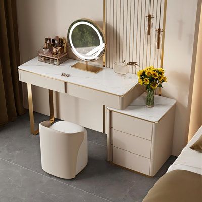 a bedroom with a vanity, stool and mirror