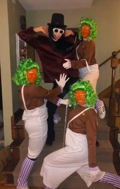 four people dressed in costumes are dancing on the stairs