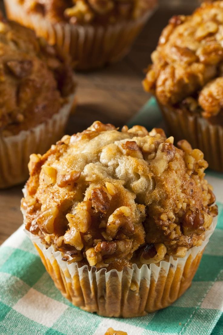 three muffins sitting on top of a green and white checkered napkin