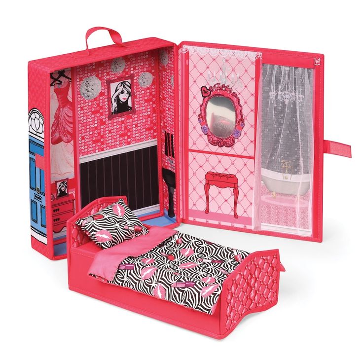 a pink doll house with a bed and furniture in it's open door area