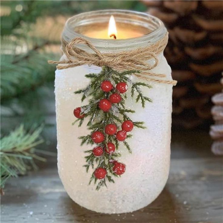 a mason jar with holly and berries on it