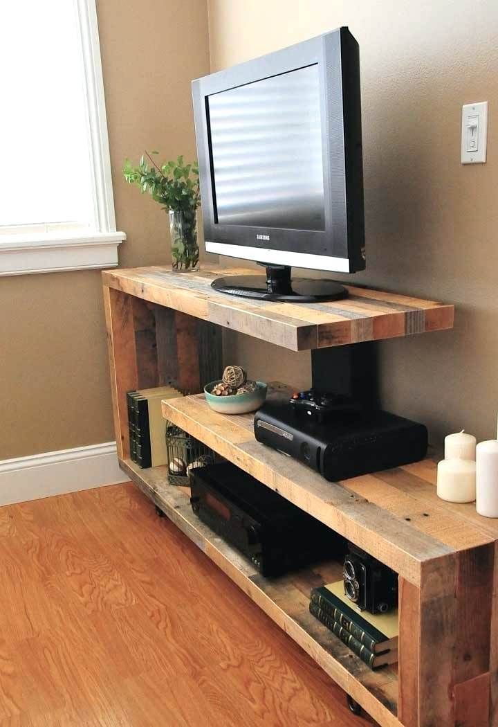 a flat screen tv sitting on top of a wooden shelf