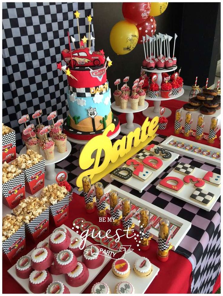 a table topped with lots of cakes and cupcakes