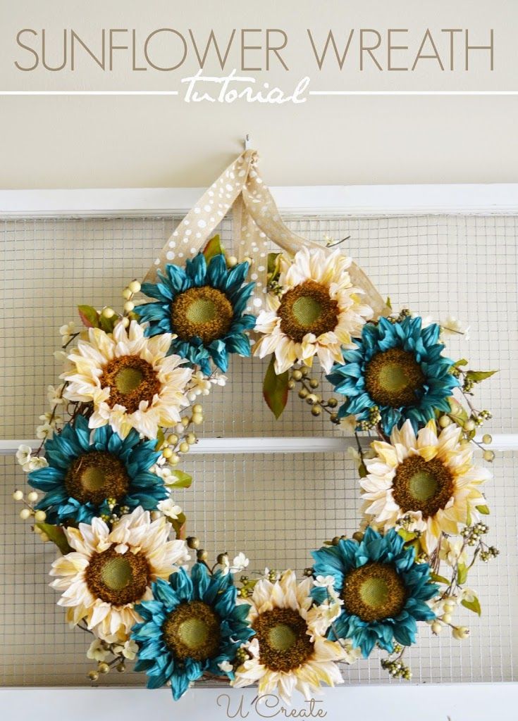 a sunflower wreath hanging on the front door