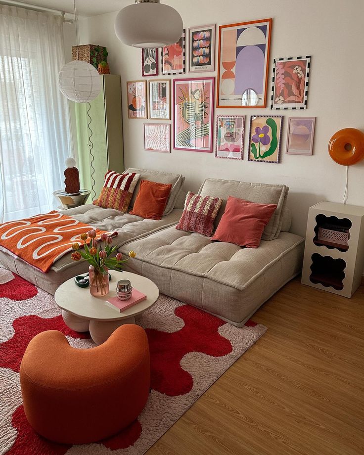 a living room filled with lots of furniture and pictures on the wall above it's couch