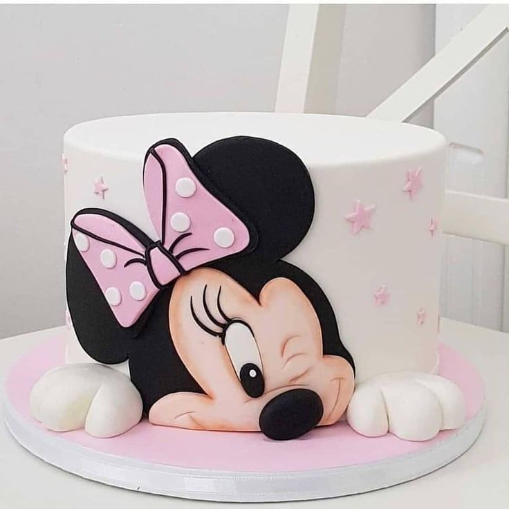 a minnie mouse cake with pink and white icing