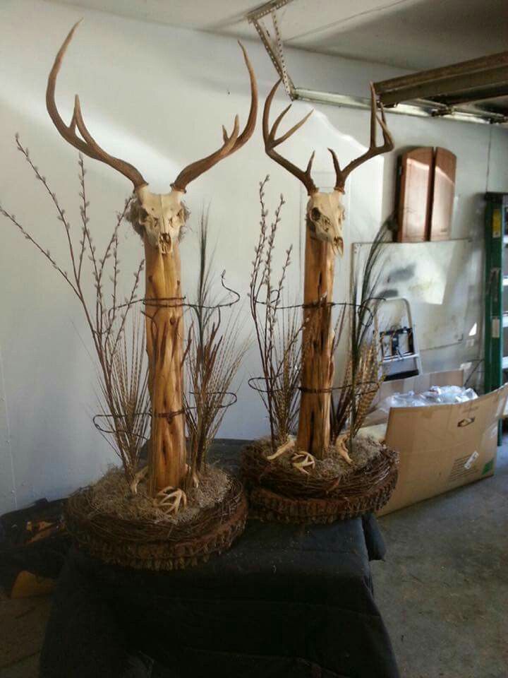 two deer heads made out of wood sticks