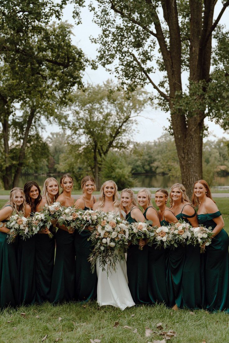 a group of women standing next to each other holding bouquets