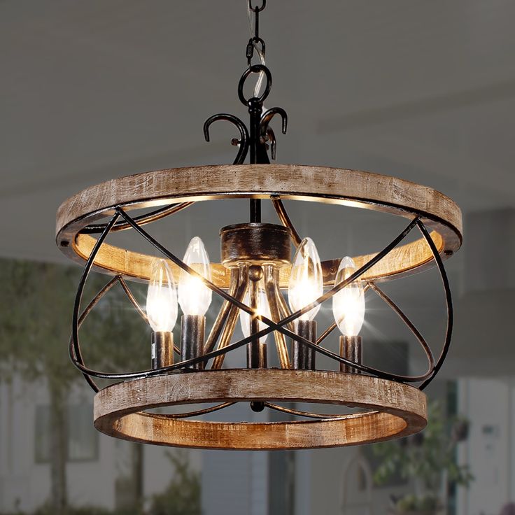 a wooden chandelier with five lights hanging from it's center circle shape